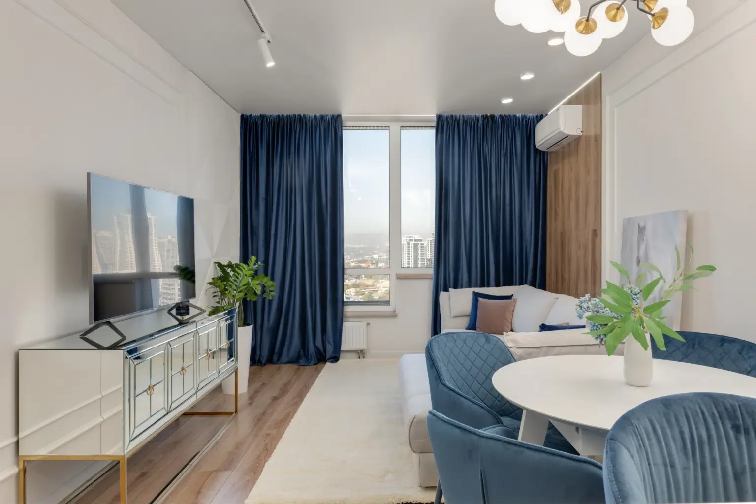 A beautiful home after installing new windows. It has blue curtains, plants, and a lot of natural light.